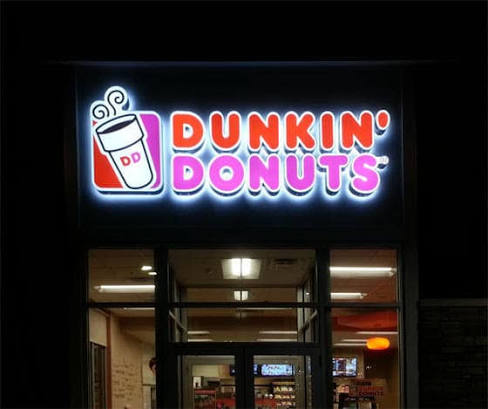 LED channel letters lighting up a business storefront at night in Central Florida