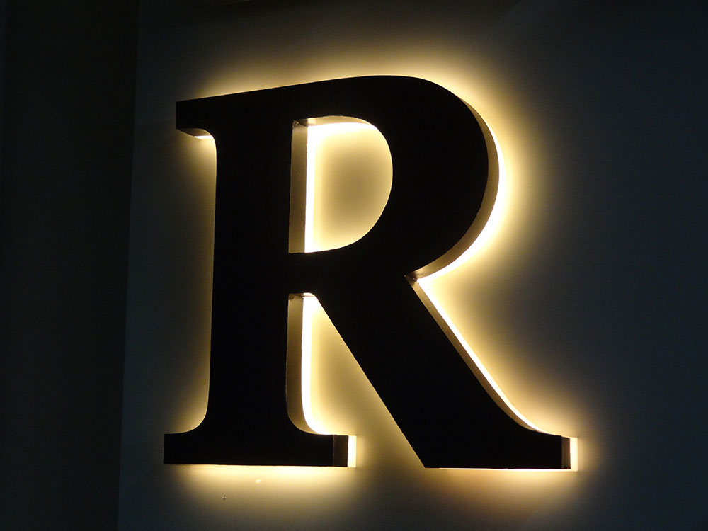 Halo-lit reverse channel letters glowing on a building in Orlando